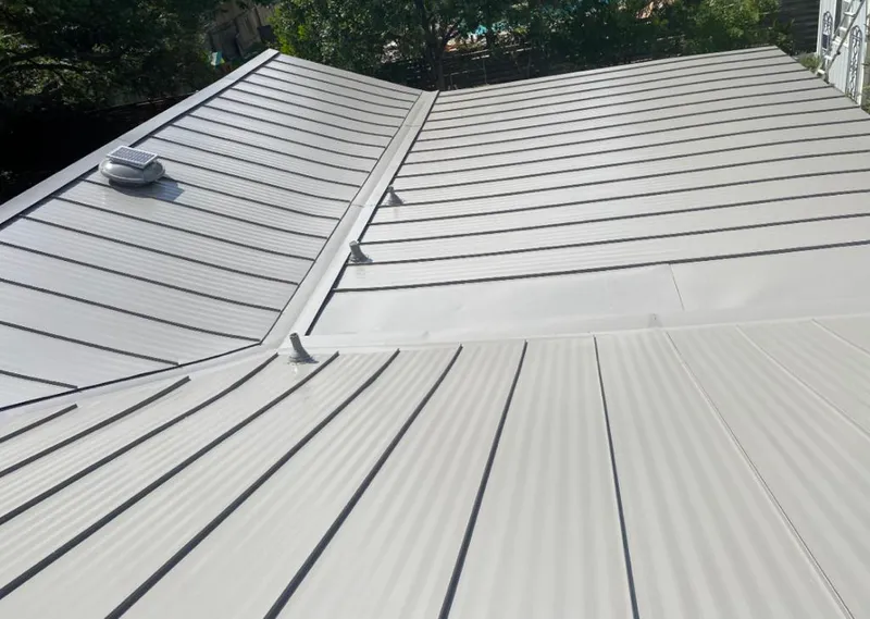 Solar attic fan installed on a metal roof for Roof Ventilation in Webster Groves